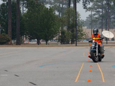 The Soldier (rider) is maneuvering his motorcycle through the cones Photo