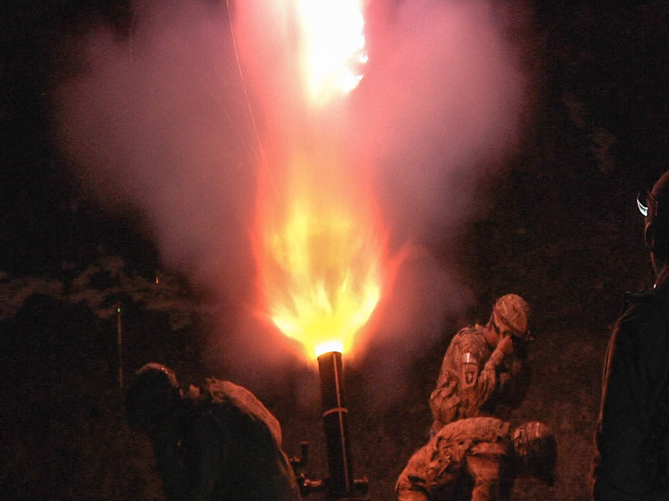 Infantrymen fire a 120mm mortar during a night-fire exercise.