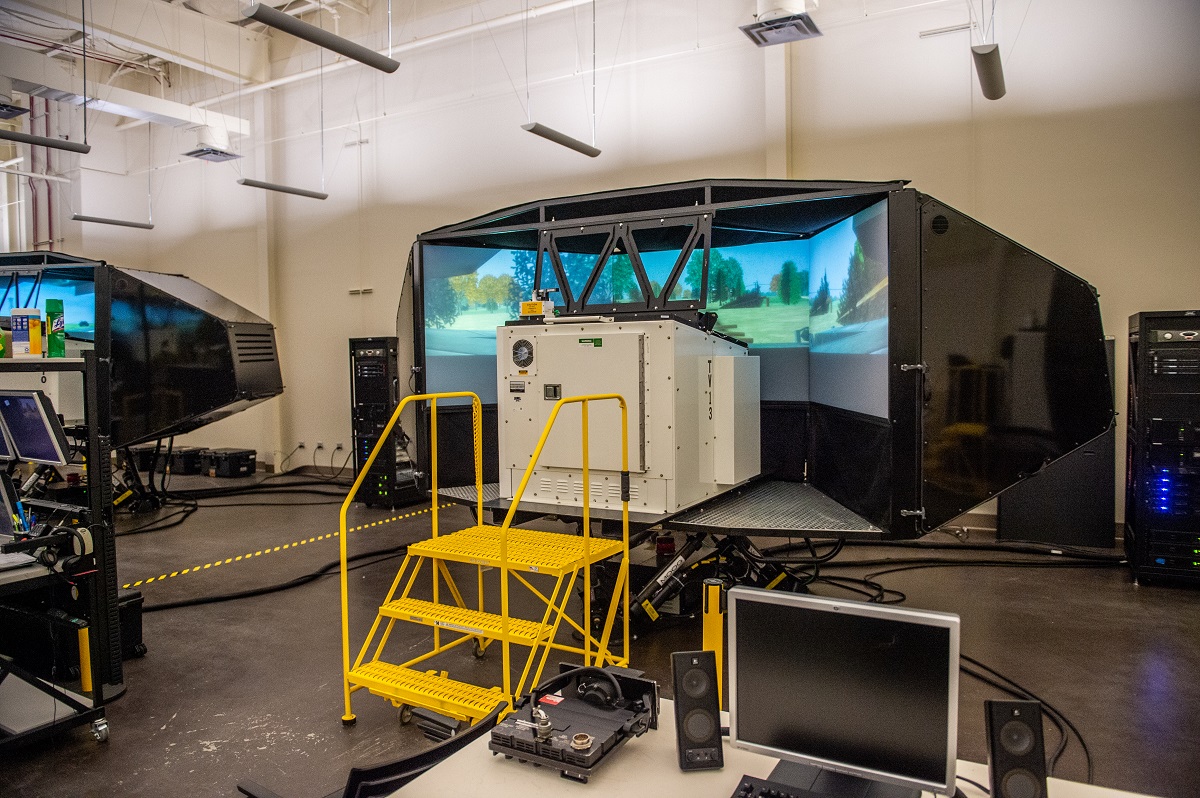 Cozzo drives a tank simulator designed to replicate in real-time the look and feel of driving a tank in a combat.    