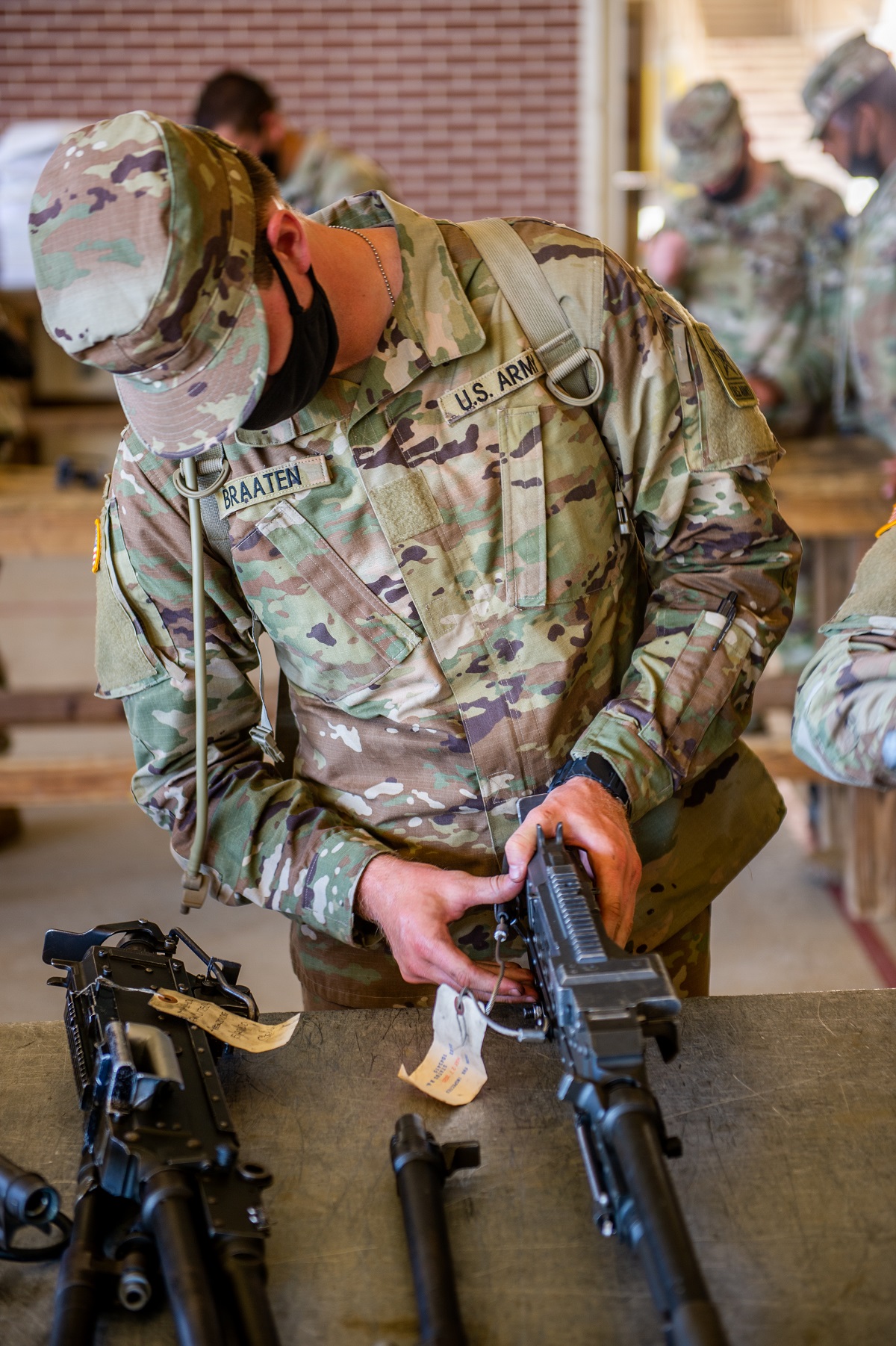 Braaten practices assembling and disassembling the M2A1 .50 Caliber Machine Gun. Trainees are required to break the gun down into eight major parts, adjust head space and timing, and reassemble the weapon.
