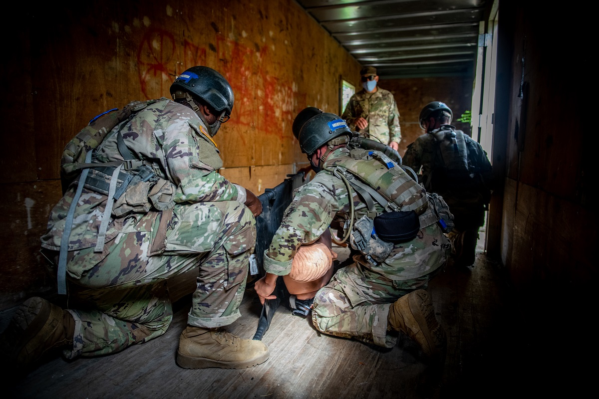 Braaten, right, works with fellow trainees to provide medical care and evacuate a casualty during a Tactical Combat Casualty Care exercise.  The intent of this training is to reduce preventable combat deaths in a way that allows a unit to complete the mission while providing the best possible care for casualties.  