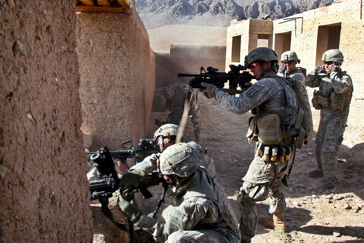 Soldiers engage enemy combatants.