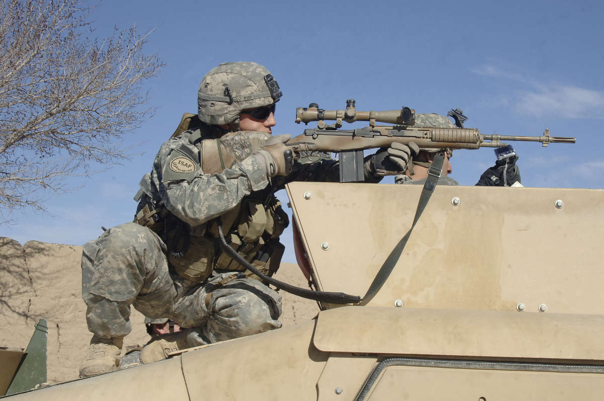 Army Sgt. from Reconnaissance Platoon looks through the scope of his rifle.