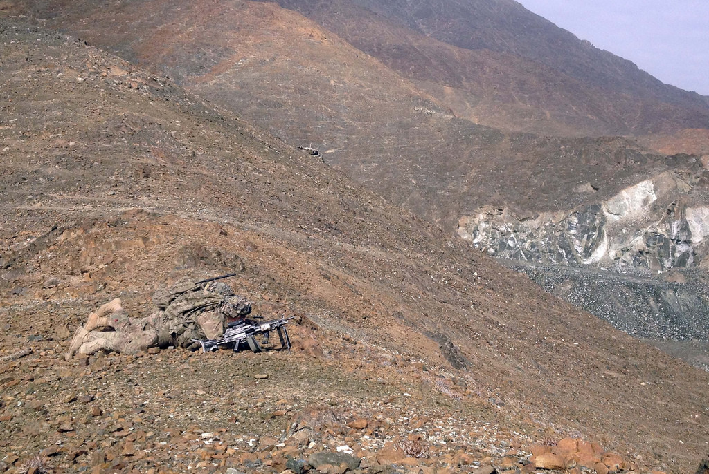 Soldiers conducting a force protection patrol scan the terrain